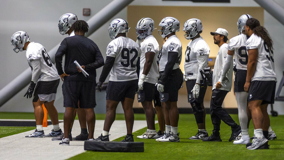 Raiders defensive tackle Thomas Booker IV (47), center, awaits his turn to push a sled during t ...