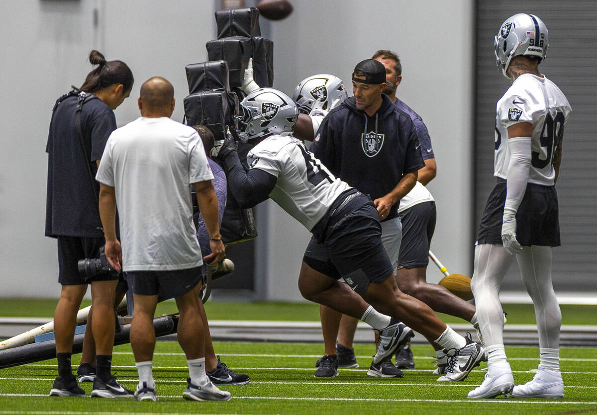Raiders defensive tackle Thomas Booker IV (47) pushes a sled during training camp in the Interm ...