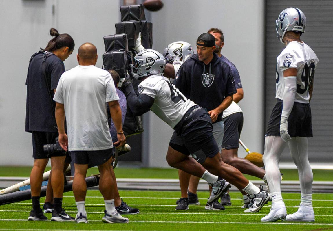Raiders defensive tackle Thomas Booker IV (47) pushes a sled during training camp in the Interm ...