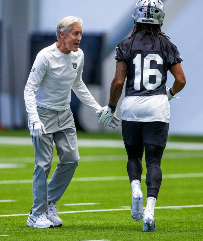 Raiders head coach Pete Carroll greets wide receiver Jakobi Meyers (16) during training camp in ...