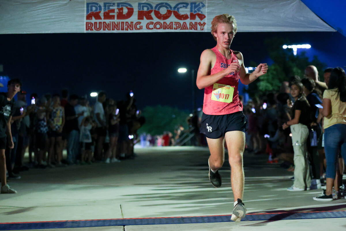 Shadow Ridge’s Cannon Bishop crosses the finish line during the Red Rock Running Company ...
