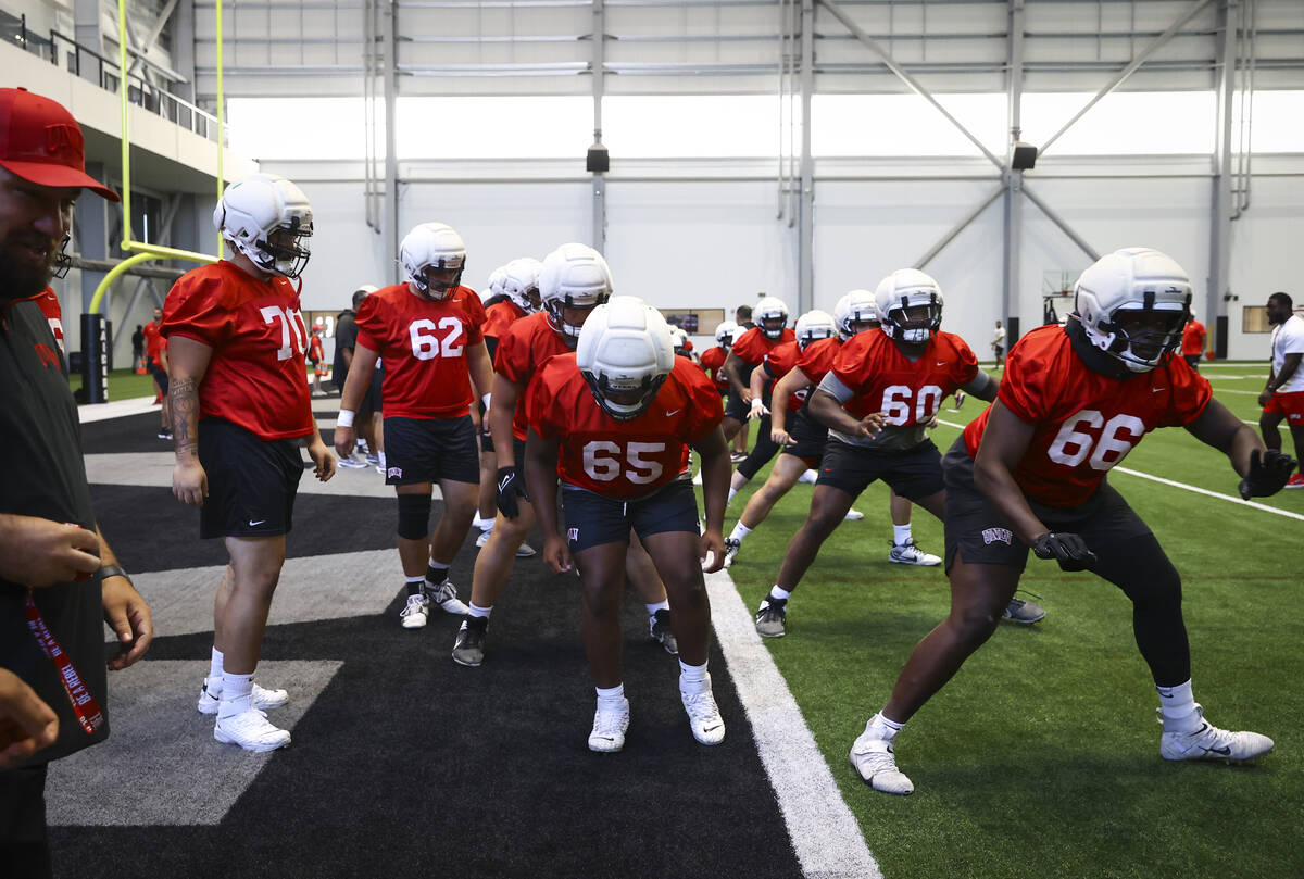 UNLV offensive lineman Ace Robinson (65) warms up with teammates during football practice at th ...