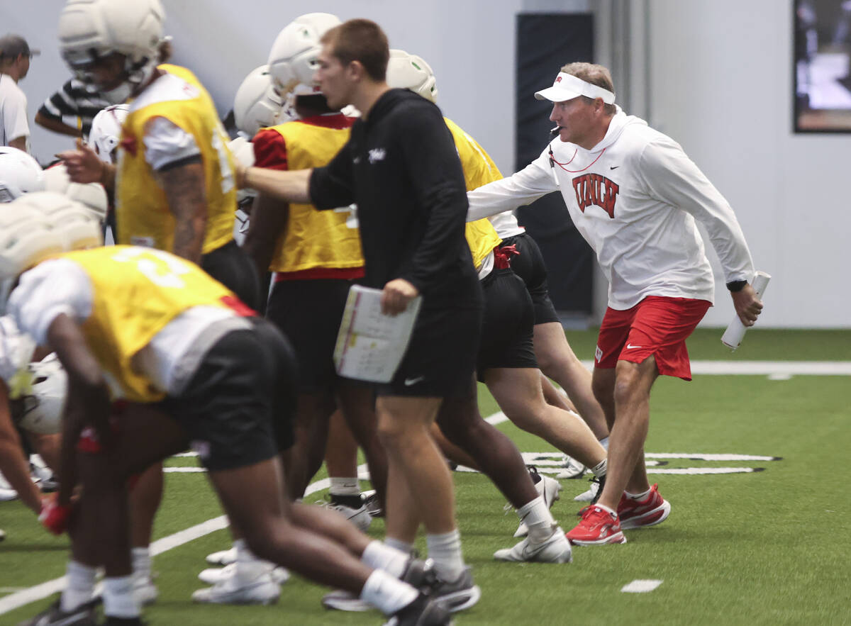 UNLV head coach Dan Mullen, right, leads the team’s football practice at the Raiders hea ...