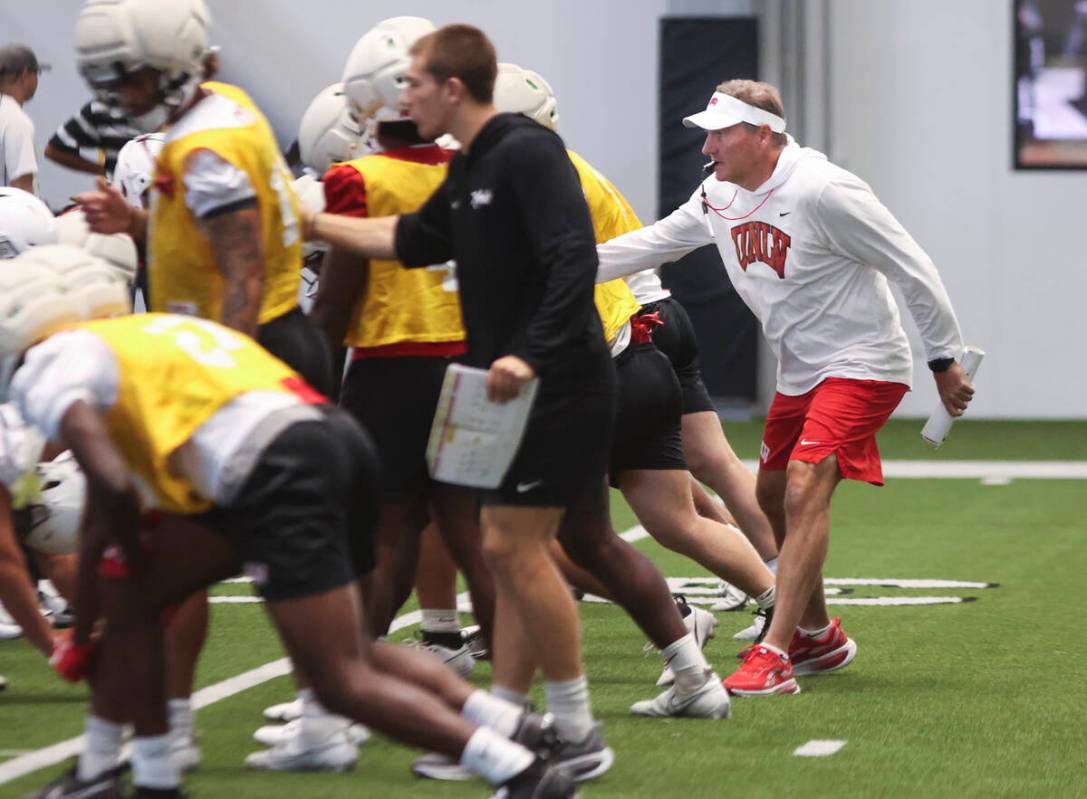UNLV head coach Dan Mullen, right, leads the team’s football practice at the Raiders hea ...