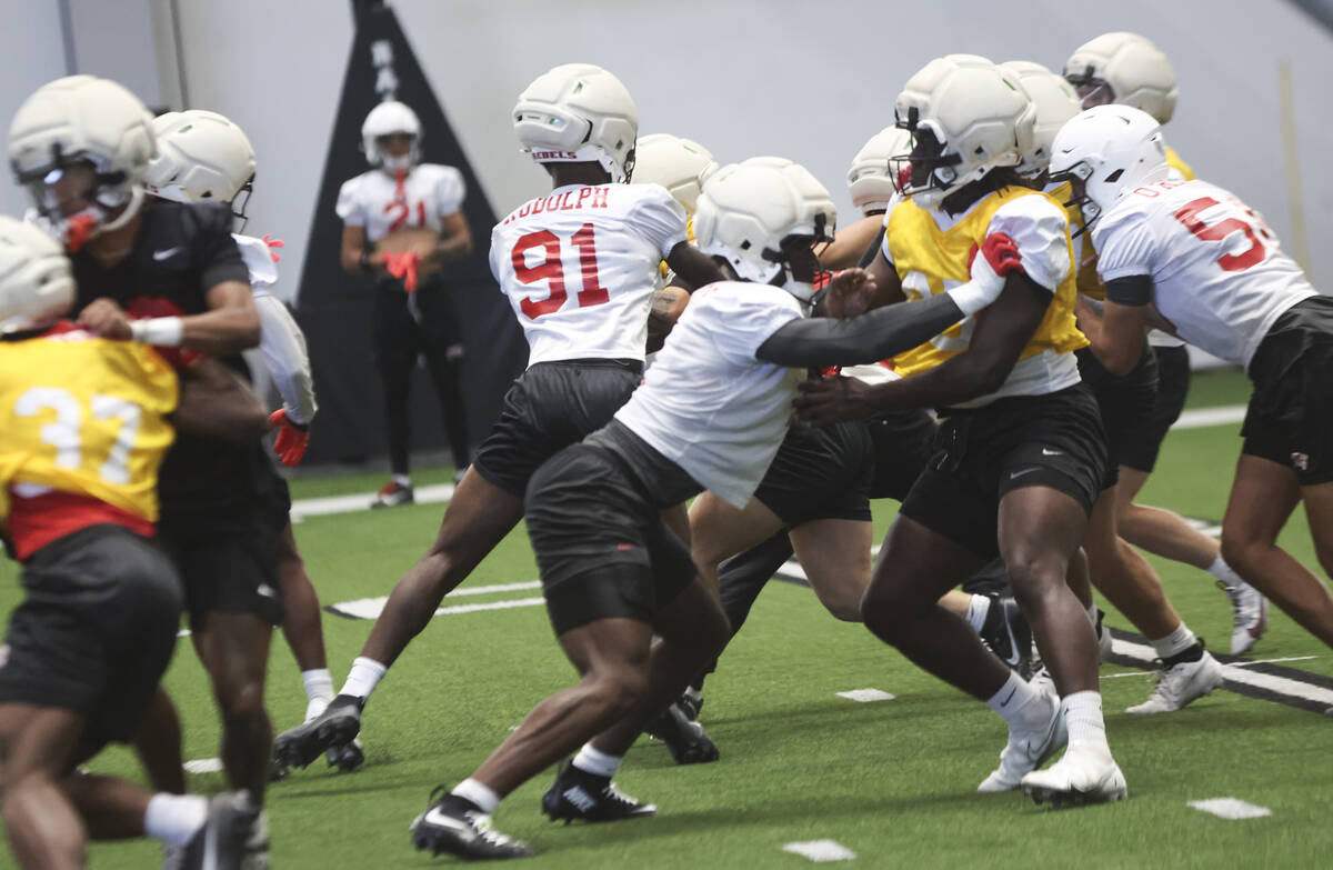 UNLV football players run through drills during practice at the Raiders headquarters and practi ...
