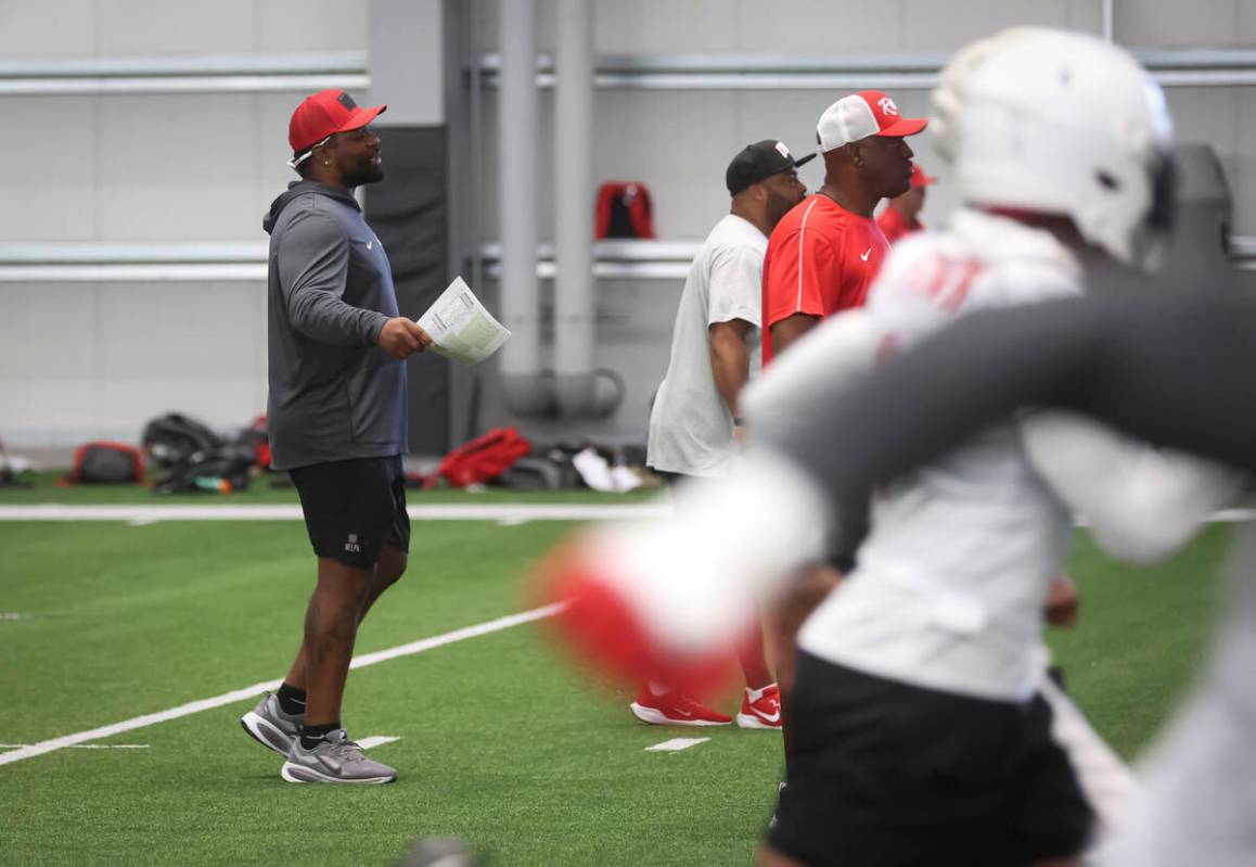 UNLV defensive analyst Vontaze Burfict, left, looks on during football practice at the Raiders ...