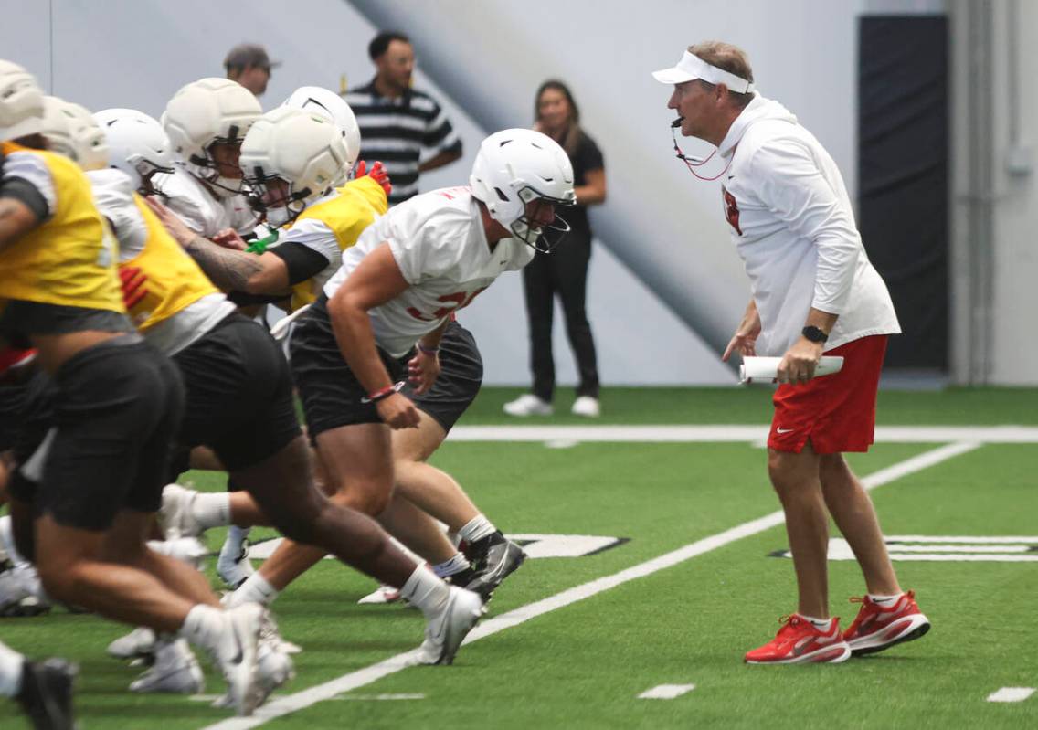 UNLV head coach Dan Mullen, right, leads the team’s football practice at the Raiders hea ...