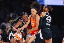 Aces guard Jackie Young (0) dribbles the ball against defense by Connecticut Sun guard Leila La ...
