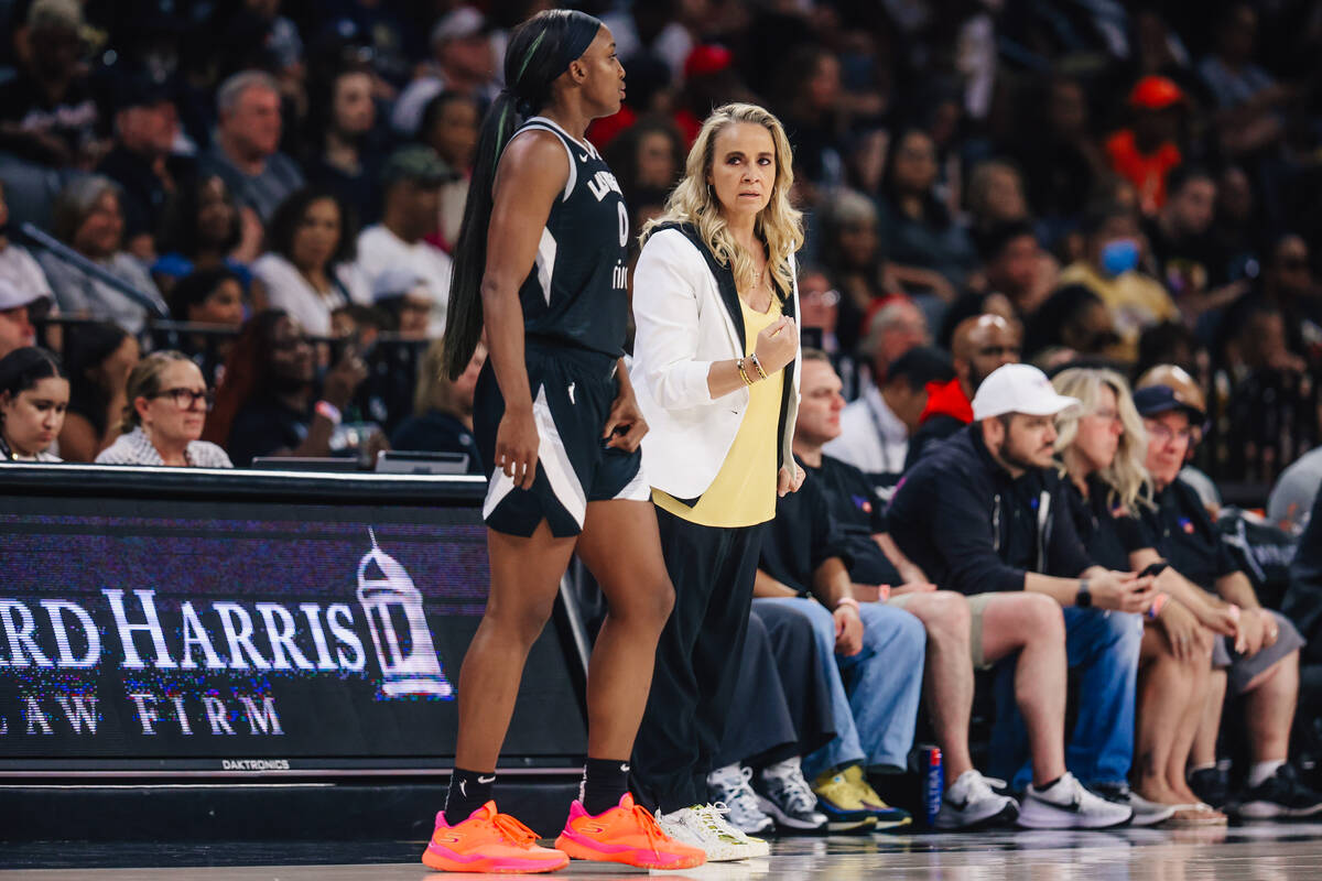 Aces guard Jackie Young (0) gets coached by Aces head coach Becky Hammon during a WNBA basketba ...