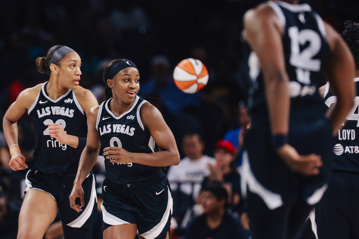 Aces guard Jackie Young (0) smiles as she runs down the court during a WNBA basketball game bet ...