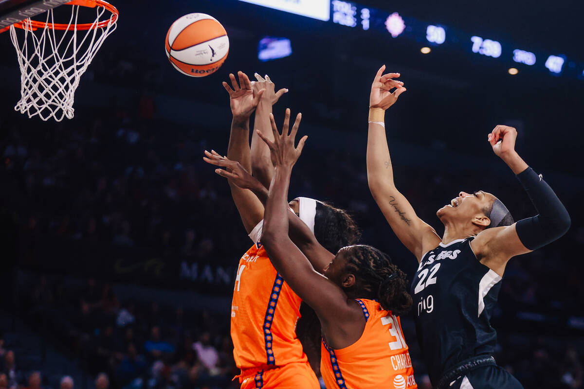 Aces center A'ja Wilson (22) puts up a shot against Connecticut Sun defense during a WNBA baske ...