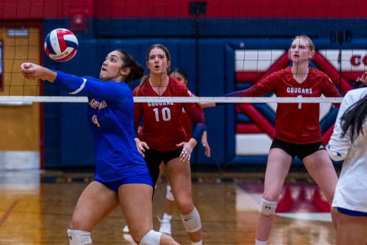 Bishop Gorman's Trinity Thompson (9) digs out a shot as Coronado's Rachel Schwartz (10) and Han ...
