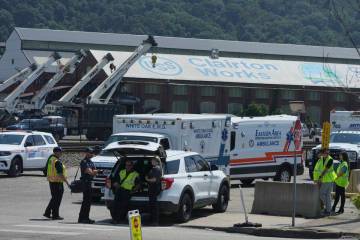 Emergency crew gather after an explosion at the Clairton Coke Works, a U.S. Steel coking plant, ...