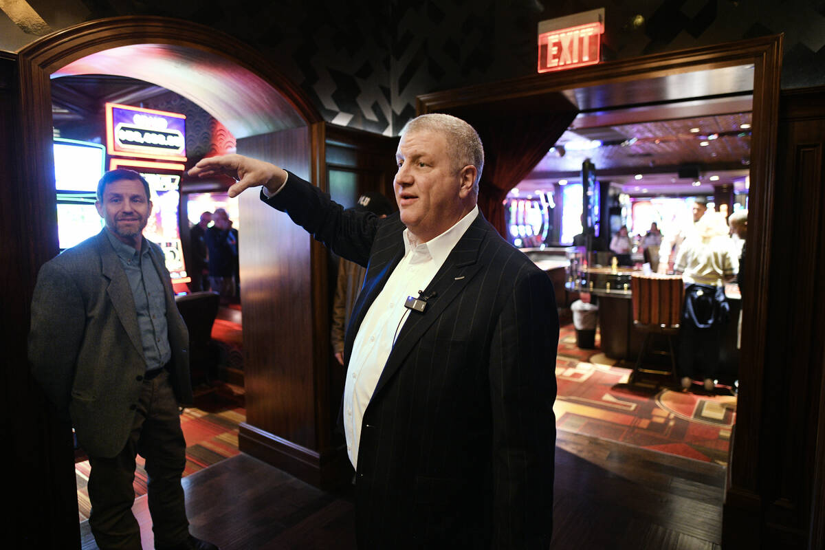 Derek Stevens describes the original archways which still exist under paneling during a tour of ...