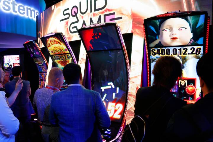 Conventioneers line up to play Squid Game at the Light and Wonder booth at G2E Las Vegas at San ...