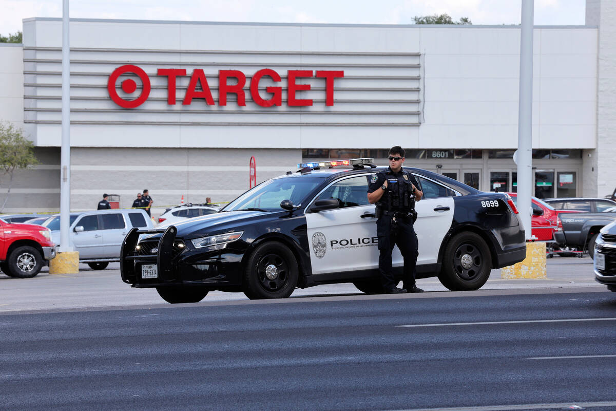Police block the entrance to a Target after a shooting in Austin, Texas, Monday, Aug. 11, 2025. ...