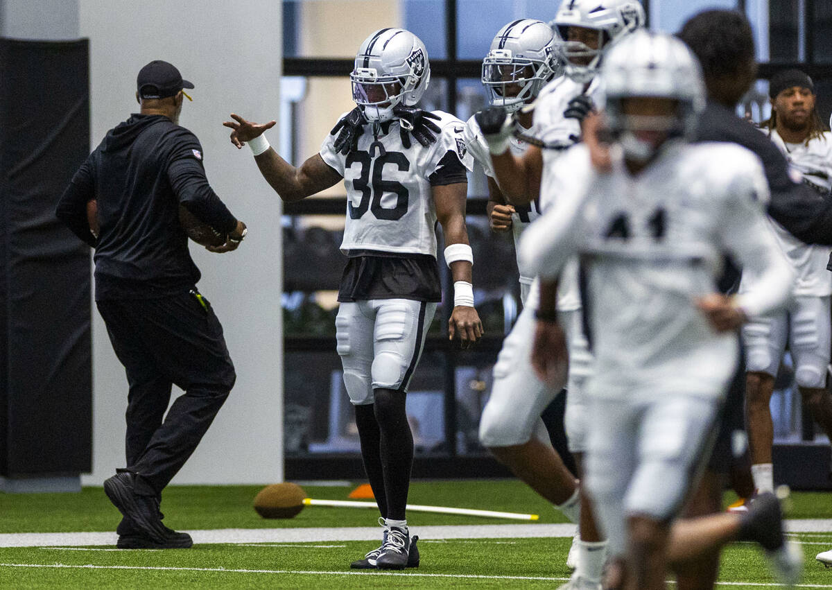 Raiders cornerback Kyu Blu Kelly (36) warms up with teammates during training camp at the Inter ...