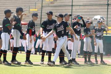 Nevada Little League baseball players, including left field Banks Mossler (5) are introduced be ...