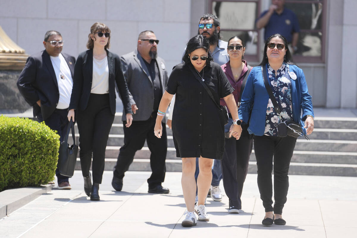 Gloria Cazares, right, holds hands with Veronica Mata during a break in a court hearing in a la ...