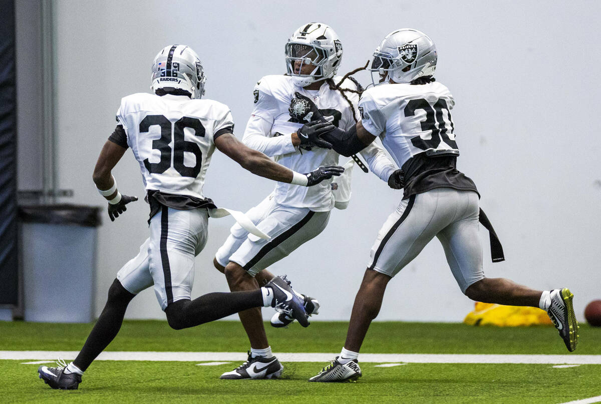 Raiders safety Terrell Edmunds (48), center, works to get to a runner past cornerback Kyu Blu K ...
