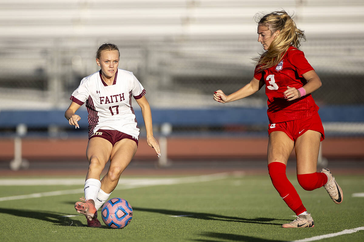 Faith Lutheran sophomore Julia Anfinson (17) passes the ball during the high school soccer game ...