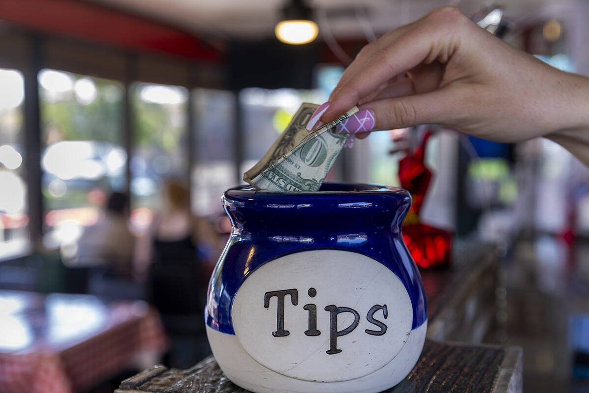 A dollar goes into the jar at the Water Street Pizzeria as the ‘No Tax on Tips’ A ...