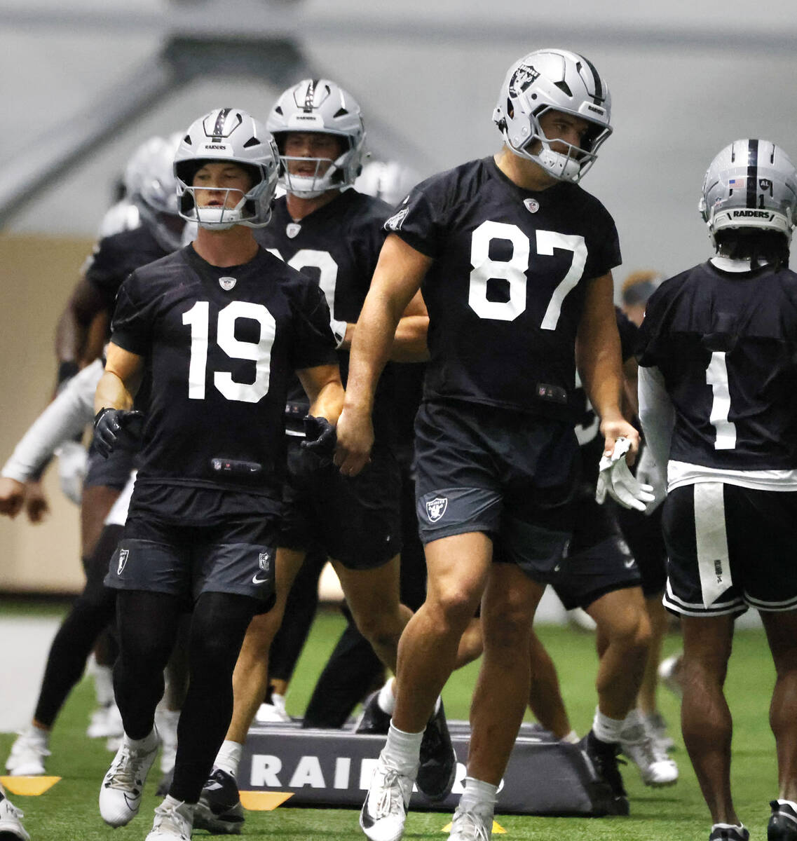 Raiders wide receiver Collin Johnson (17) and tight end Michael Mayer (87) work on drills durin ...