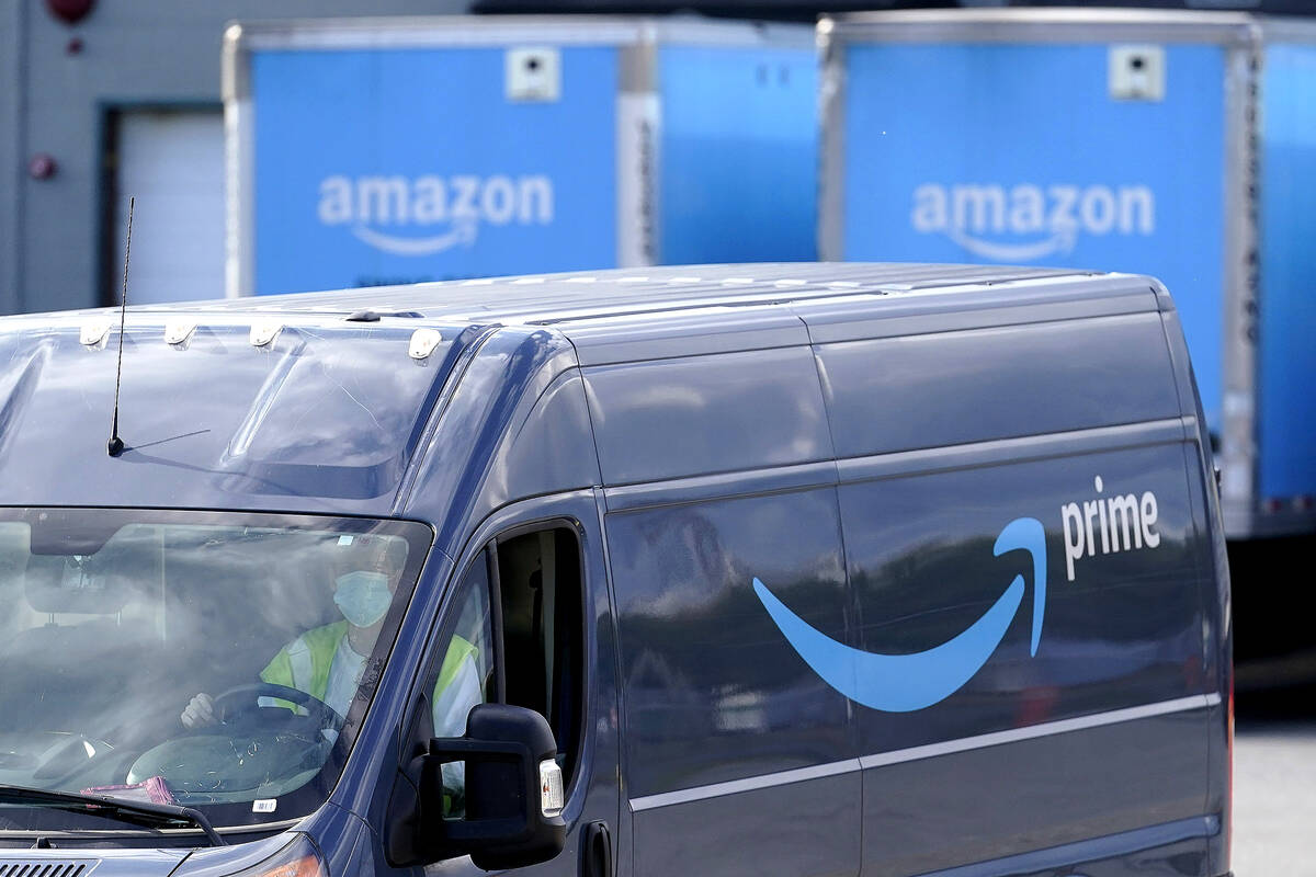 FILE - An Amazon Prime logo appears on the side of a delivery van as it departs an Amazon Wareh ...