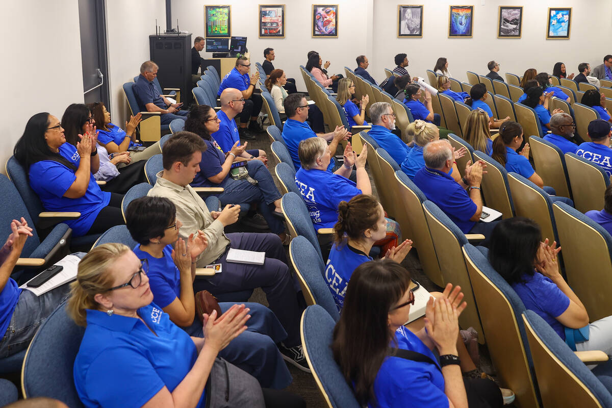 People clap after the Clark County School District Board of Trustees approved a contract that w ...