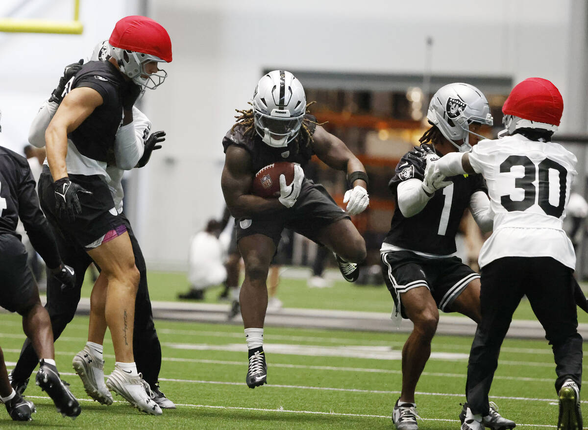 Raiders running back Ashton Jeanty (2) runs with the ball during training camp at the Intermoun ...