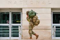 A member of the District of Columbia National Guard arrives at the District of Columbia Nationa ...