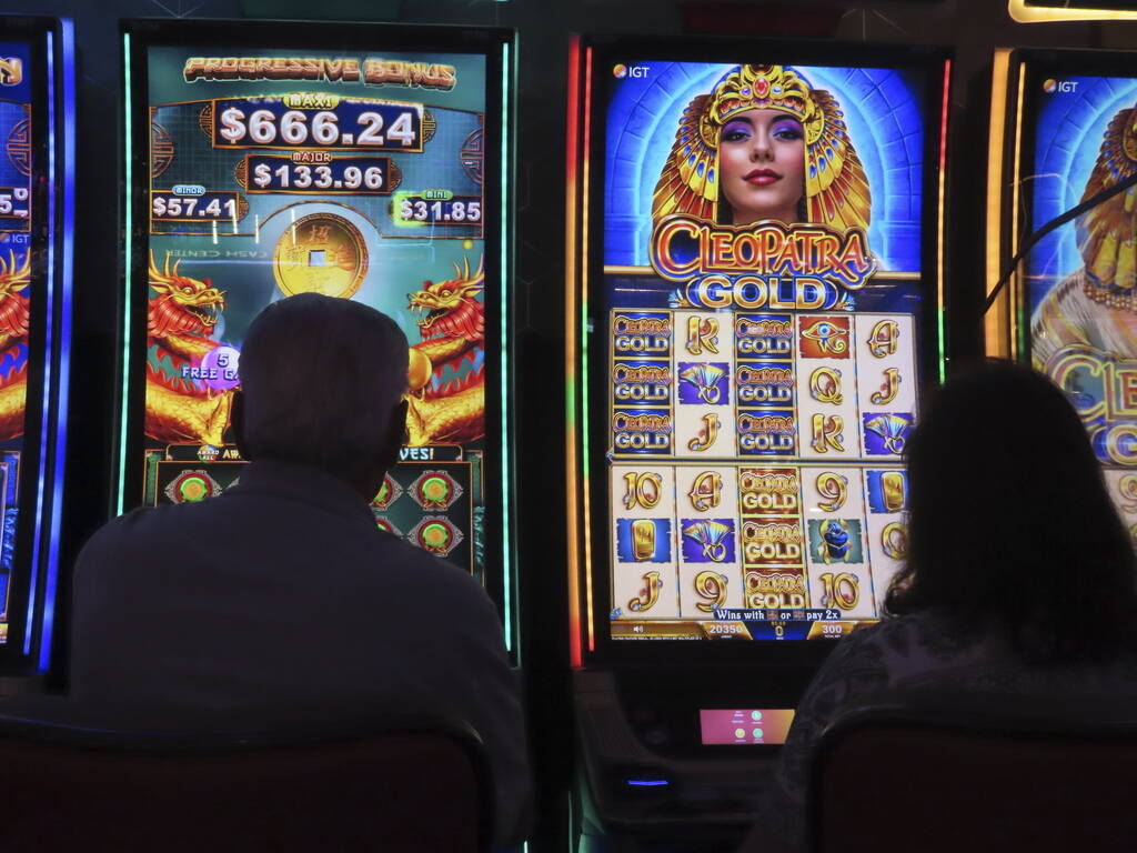 Gamblers play slot machines at the Hard Rock casino in Atlantic City, N.J., on Aug. 8, 2022. (A ...