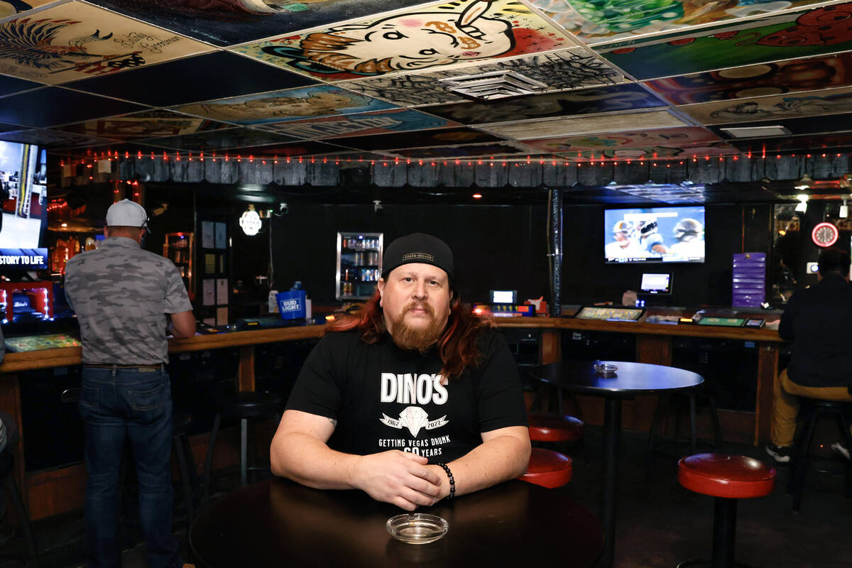 Erik Rensch, a bartender at Dino’s Lounge, poses for a photo inside the lounge on Thursd ...