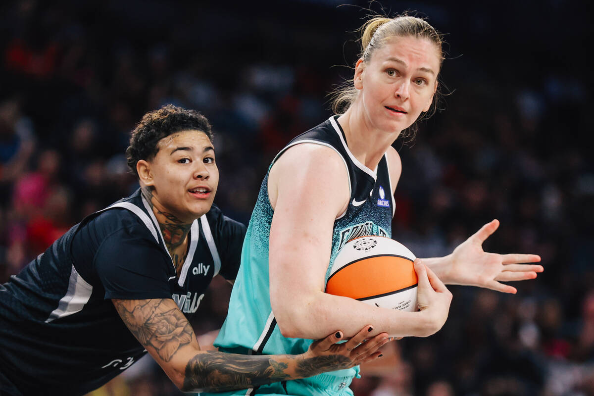 Aces forward Kierstan Bell (1) holds onto New York Liberty center Emma Meesseman (33) as she si ...