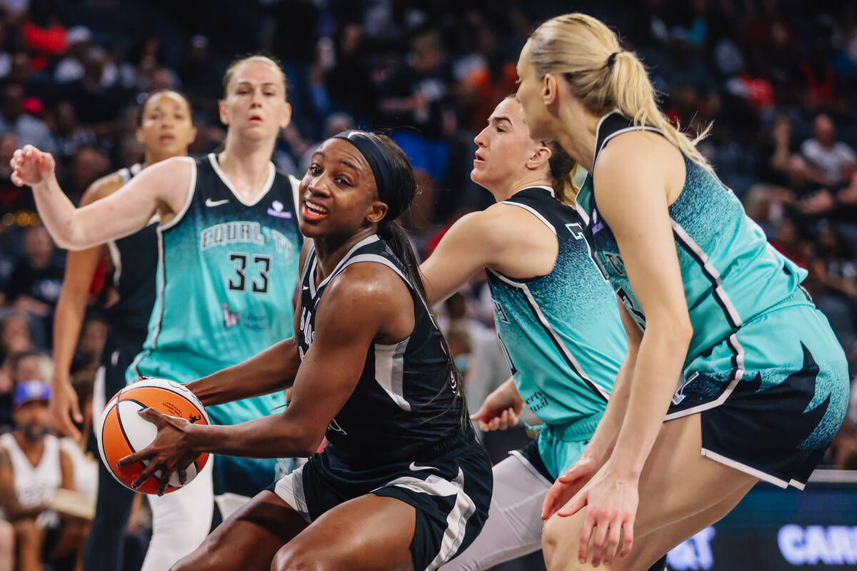 Aces guard Jackie Young (0) tries to work the ball away from New York Liberty defenders during ...