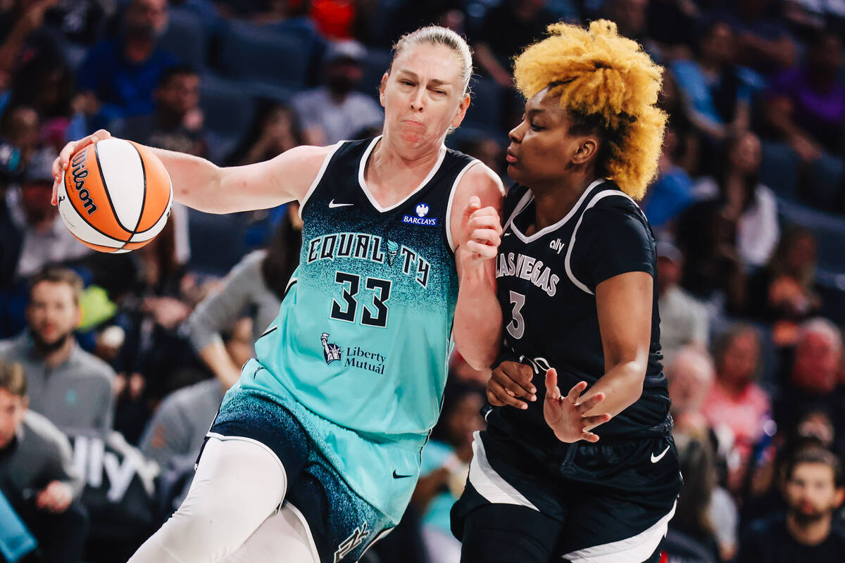 New York Liberty center Emma Meesseman (33) moves the ball against Aces forward NaLyssa Smith ( ...