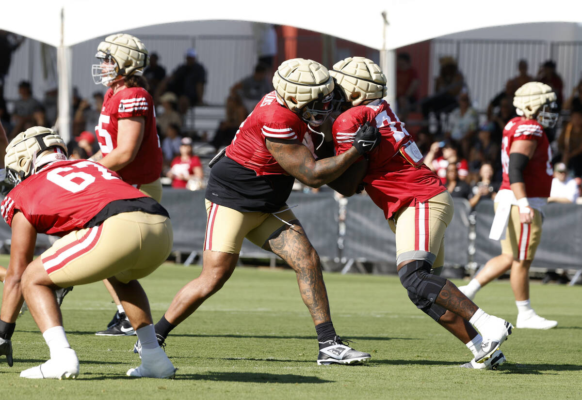 San Francisco 49ers tight end Trent Williams, left, and offensive lines Spencer Burford work on ...