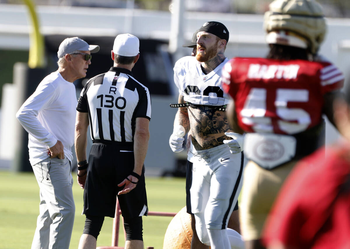 Raiders defensive end Maxx Crosby (98) runs past head coach Pete Carroll, left, and San Francis ...