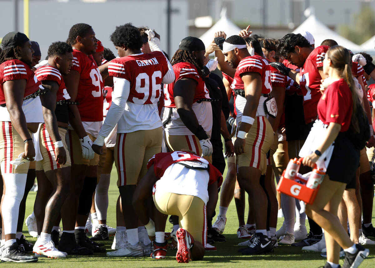 San Francisco 49ers players hudle before a joint practice with Raiders at the Intermountain Hea ...
