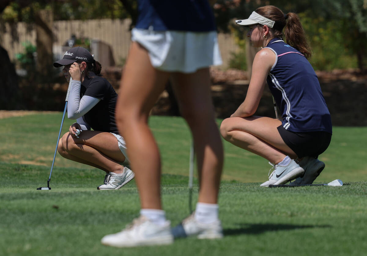 Shadow Ridge’s Holly Rodriguez, left, and Centennial’s Mia Meyers read the green ...