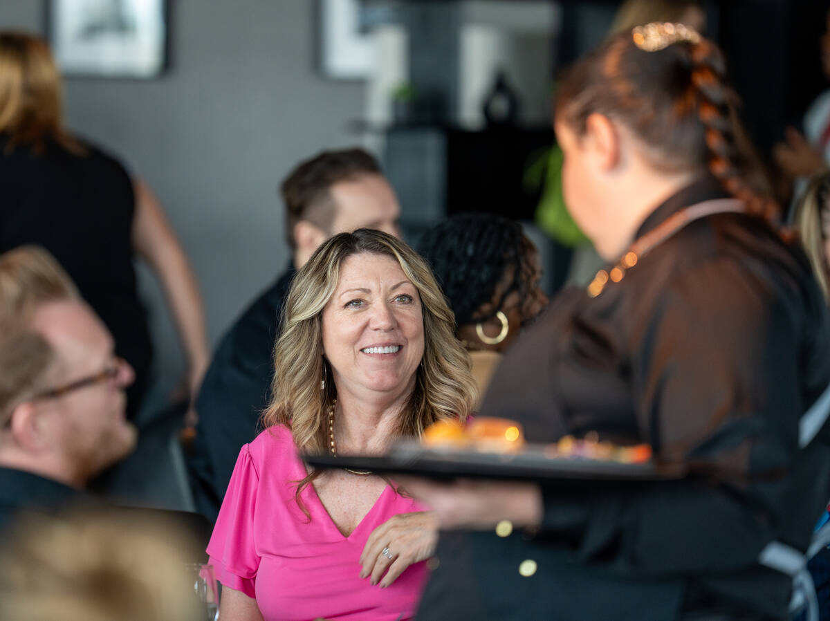 Guests enjoy lunch before five $20,000 donation checks are presented to local organizations dur ...