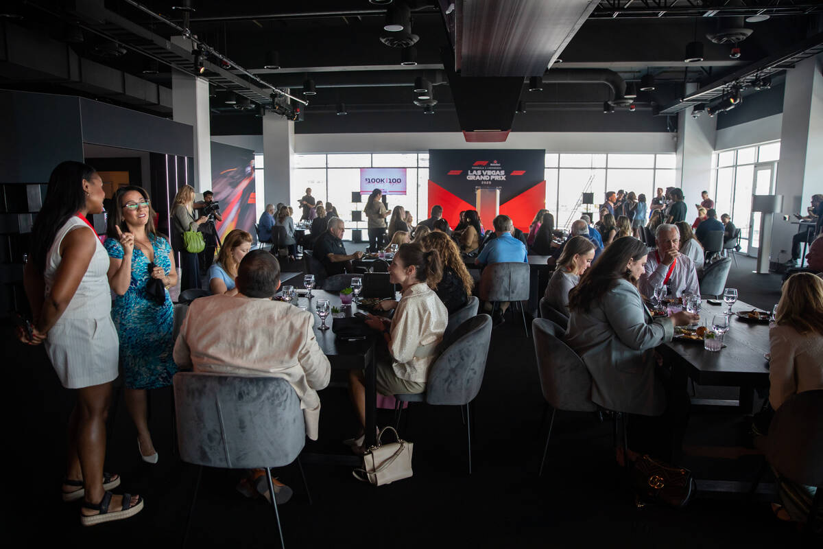 Guests enjoy lunch during a Formula One Las Vegas Grand Prix reception in Las Vegas, Aug. 14, 2 ...
