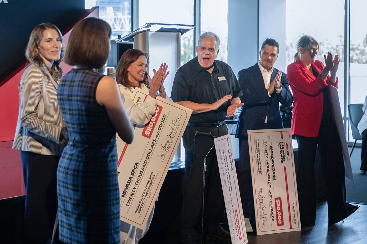 Recipients of the donations applaud before posing for a group picture during a luncheon recepti ...