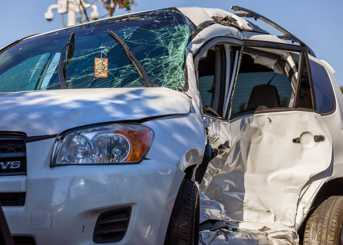 One of several damaged vehicles are towed following a crash with a school bus at North Bruce St ...