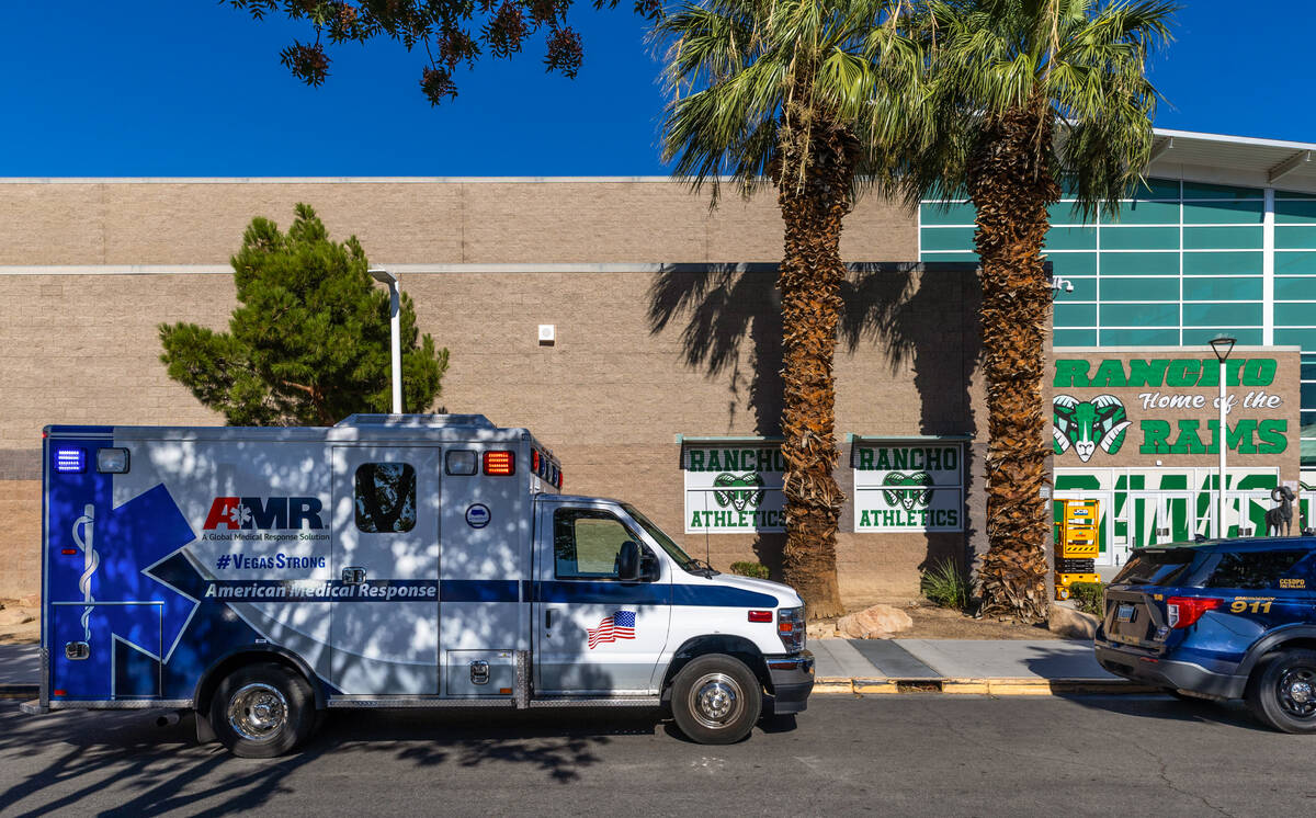 Ambulances and Clark County School District officer vehicles are staged at Rancho High School f ...