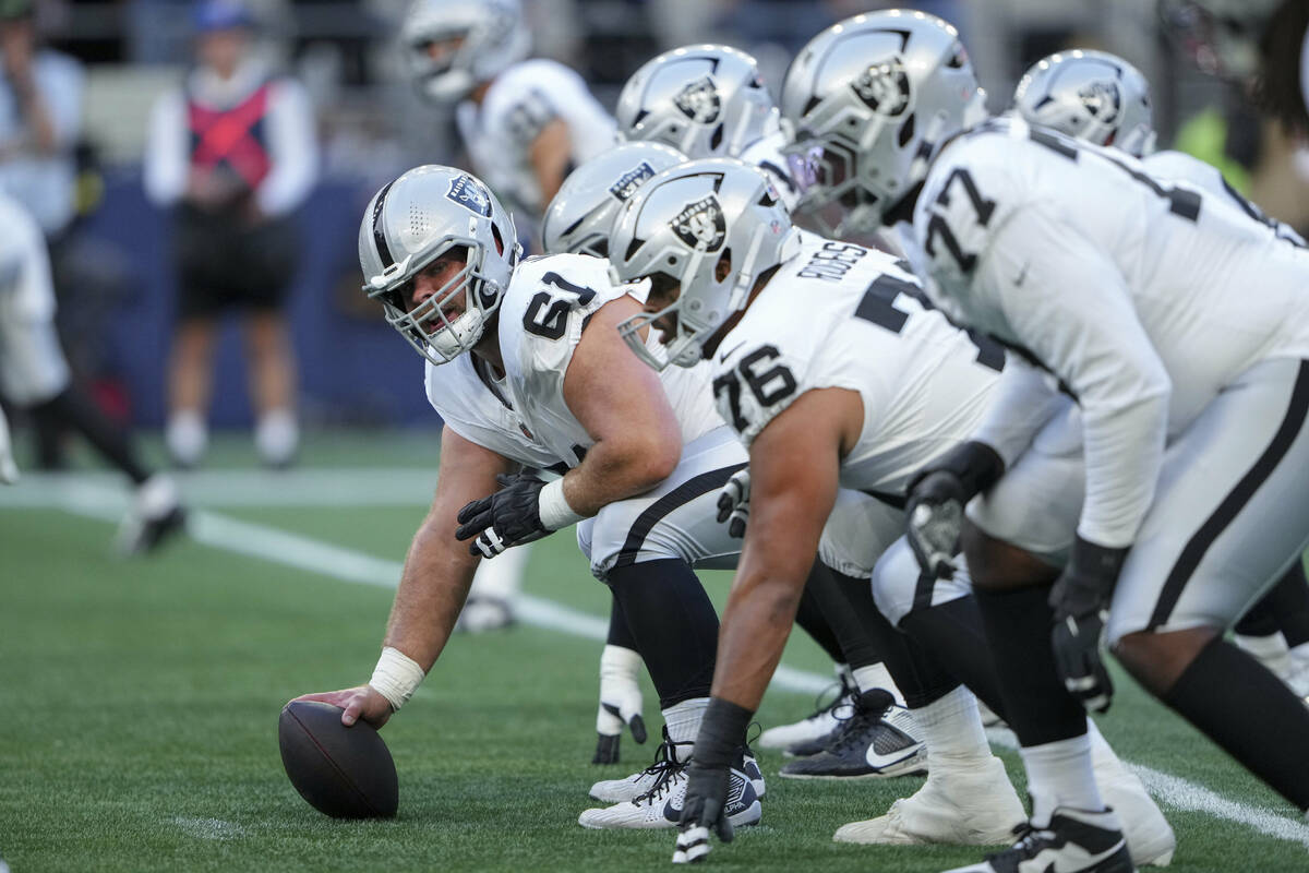Las Vegas Raiders guard Jordan Meredith (61) prepares to snap the ball during the first half of ...