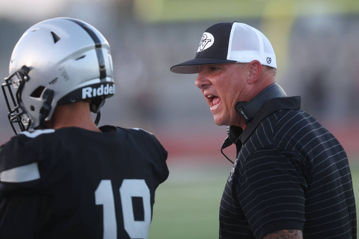 Palo Verde coach Joe Aznarez, right, coaches up kicker Brendon Siqueiros (19) during the first ...