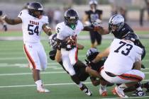 Las Vegas wide receiver Dasean Deayon (5) is tackled by Palo Verde defenders Beau Gardineer (4) ...