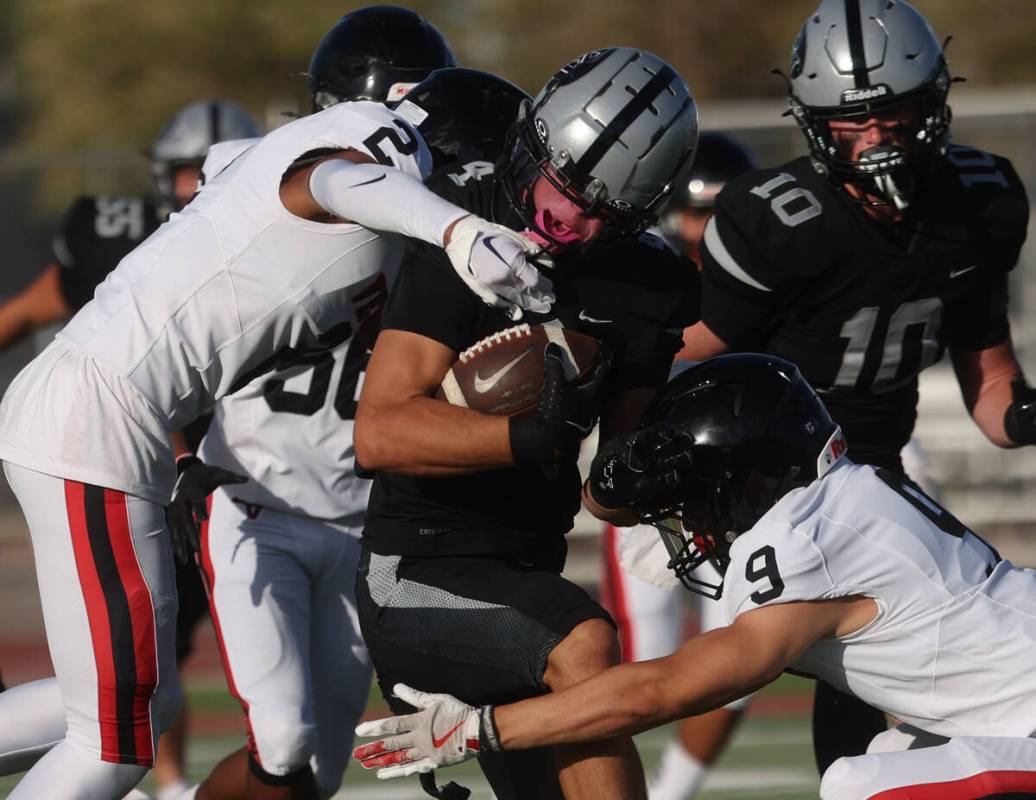 Palo Verde wide receiver Beau Gardineer (4) is tackled by Las Vegas defensive back Aiden Weigum ...