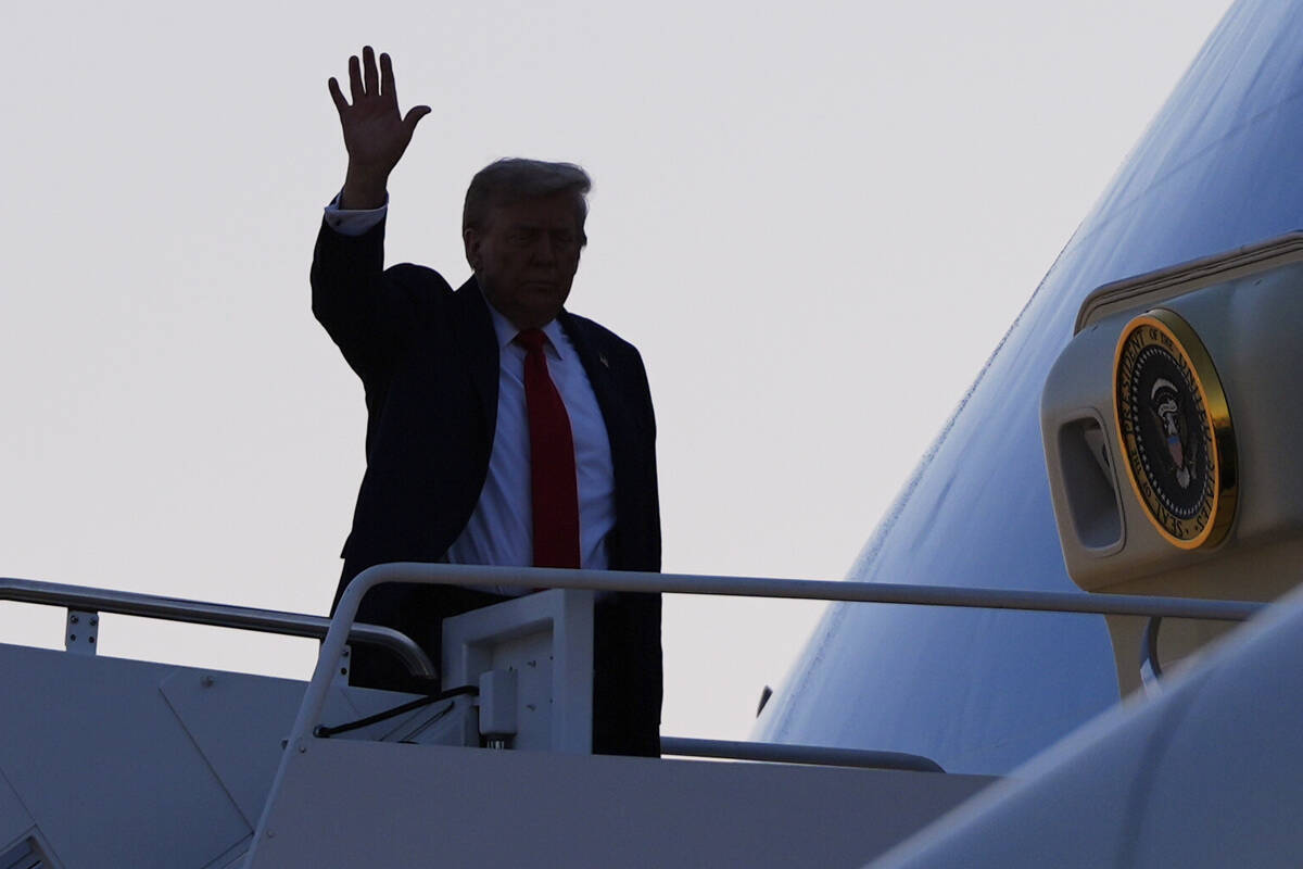 President Donald Trump waves as he boards Air Force One, Friday, Aug. 15, 2025, at Joint Base A ...